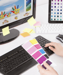 graphic designer at computer with colour swatch