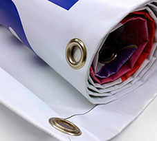 Rolled up large outdoor banner printed, hemmed and eyeleted.